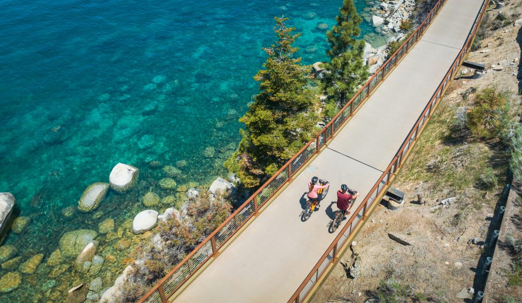 Aerial Photo of Couple Biking Along the Paved East Shore Trail in North Lake Tahoe Along the Lake