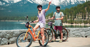 people on e-bikes with mountains in the background
