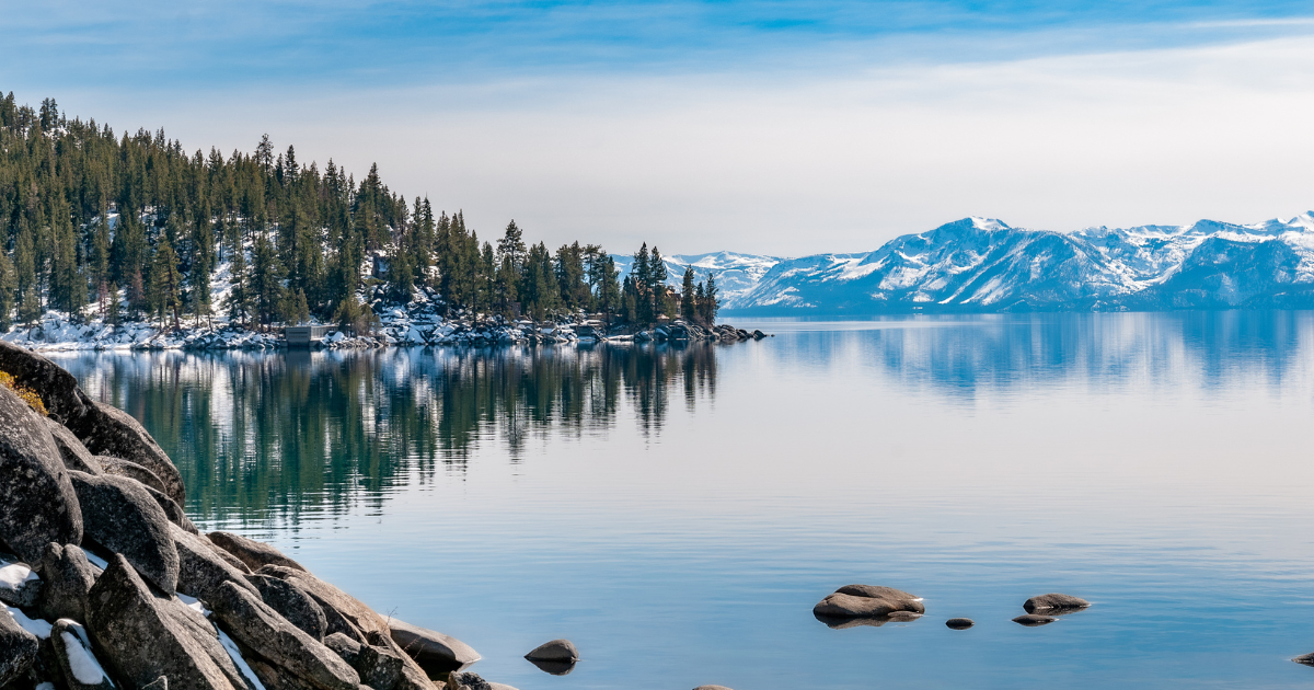 lake tahoe with snow capped mountains in the back