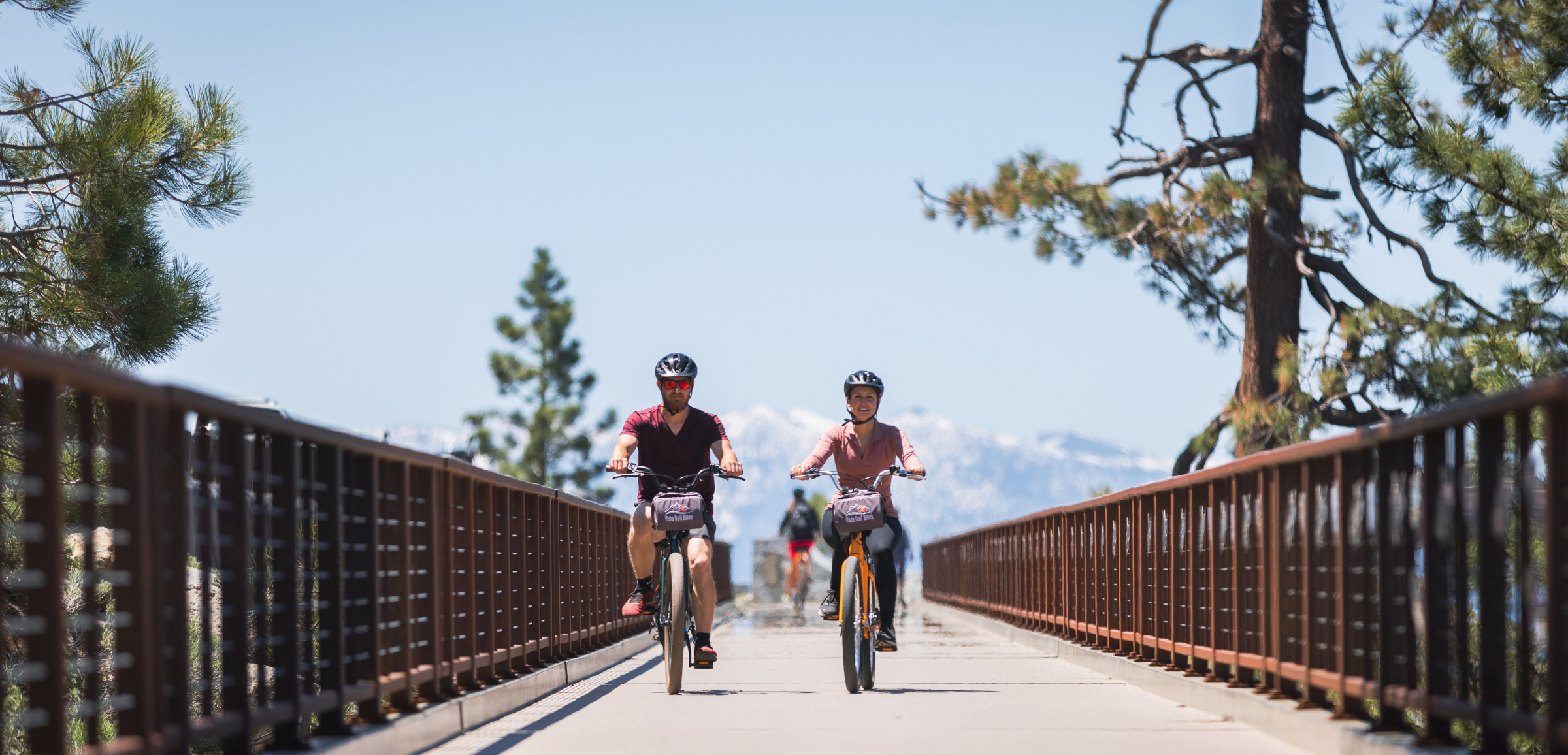two people e-biking on lake tahoe path