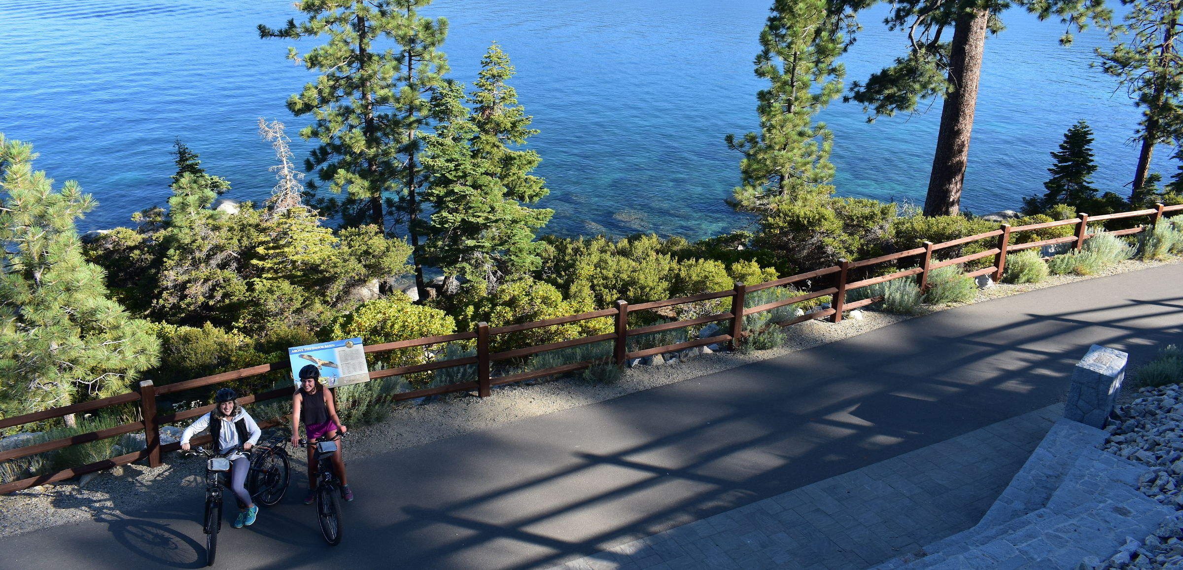 two people e-biking on lake tahoe path